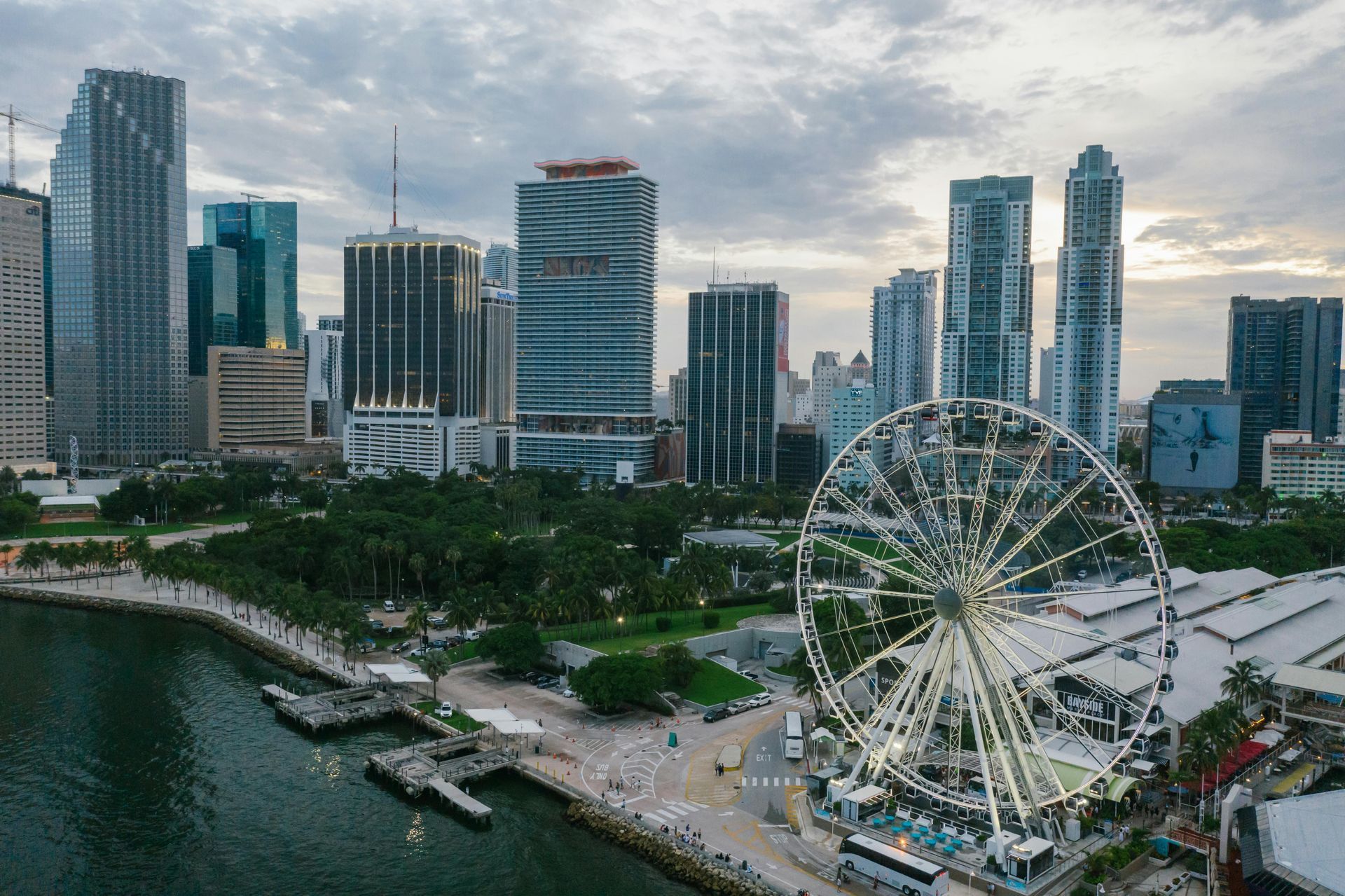 An aerial view of a city skyline with a ferris wheel in the foreground.