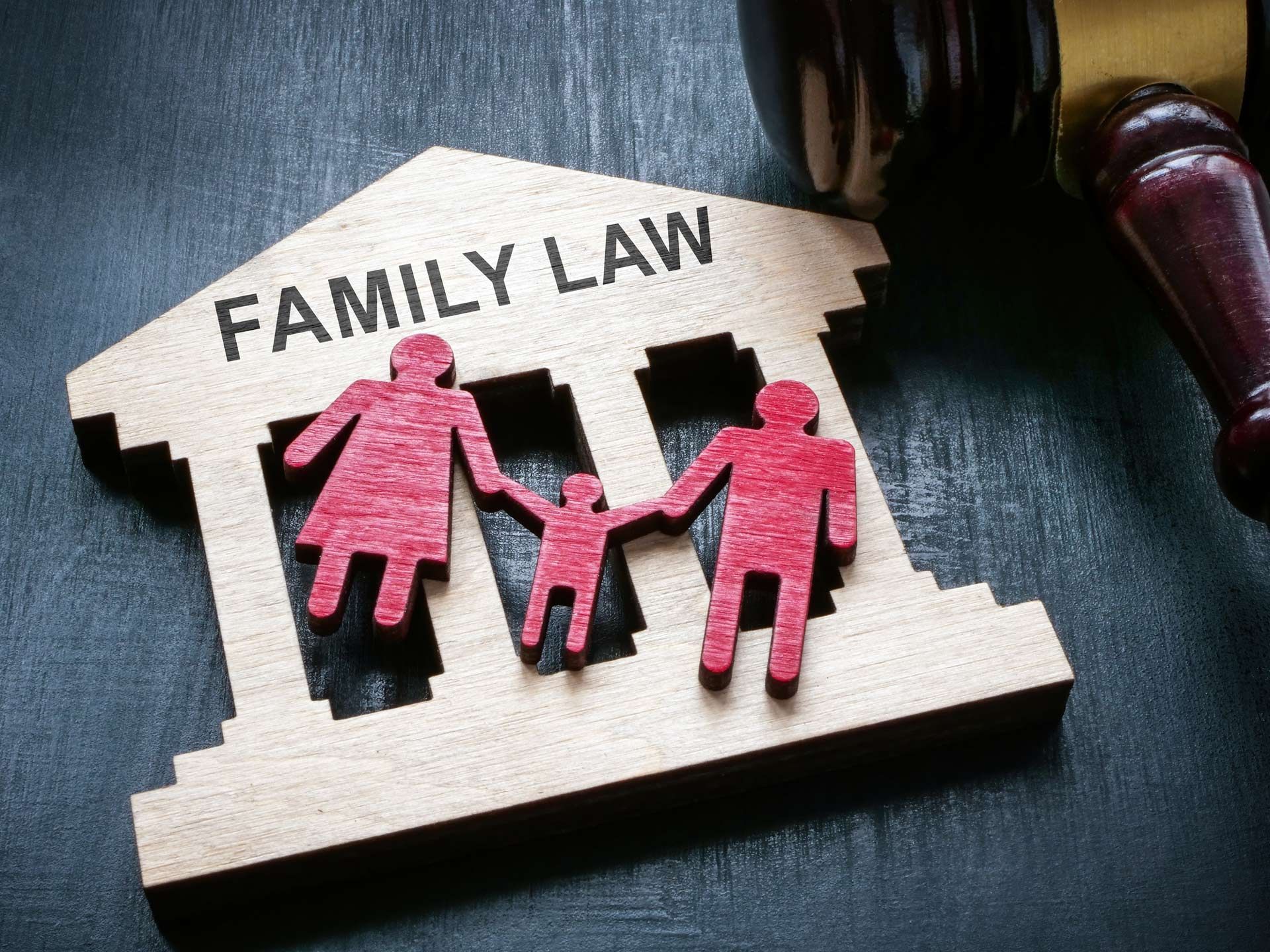A wooden model of a family law building with a judge 's gavel.