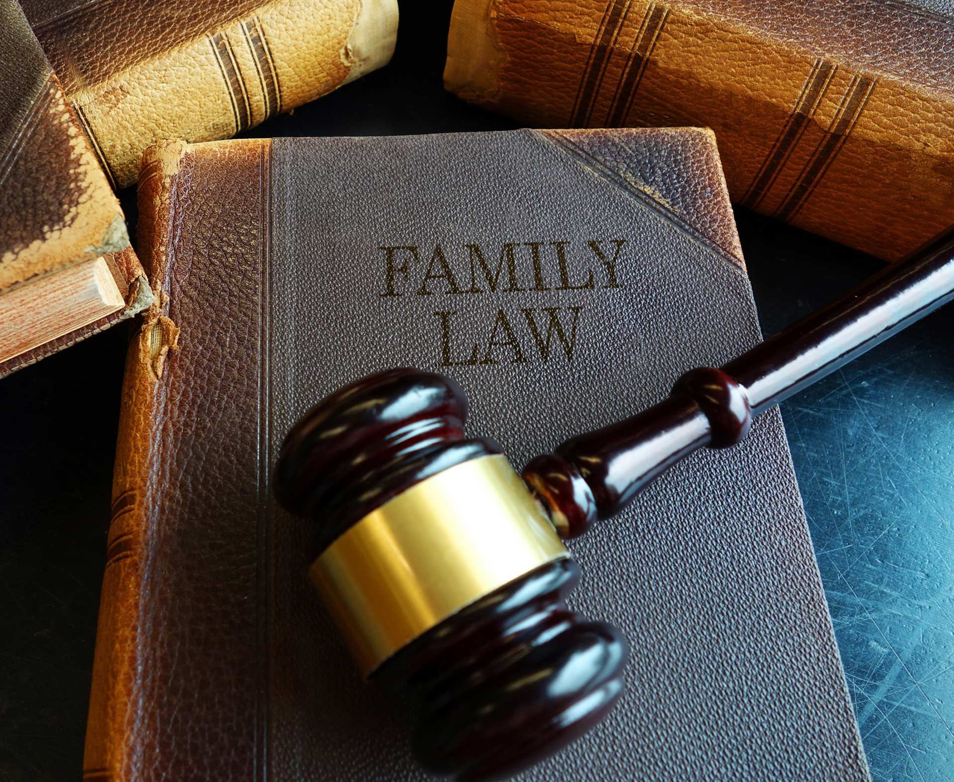 A wooden gavel is sitting on top of a family law book