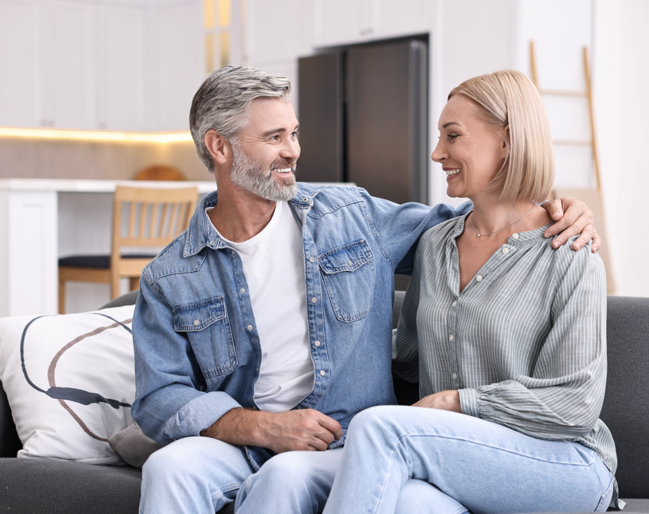Man with glasses wearing a blue striped shirt and tie, looking at the camera.