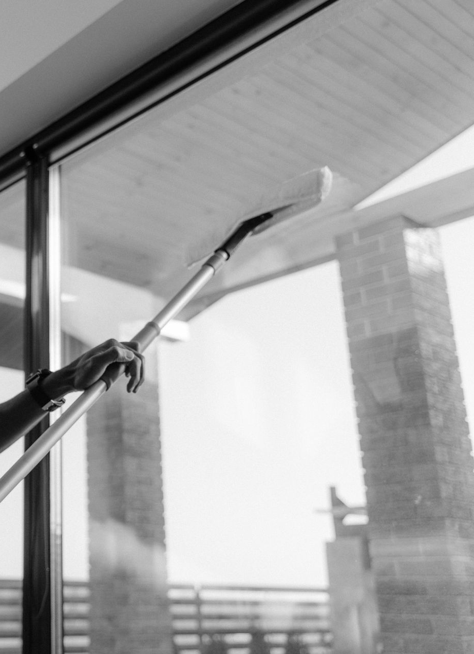 A man in a protective suit is sitting at a table in a clean room.