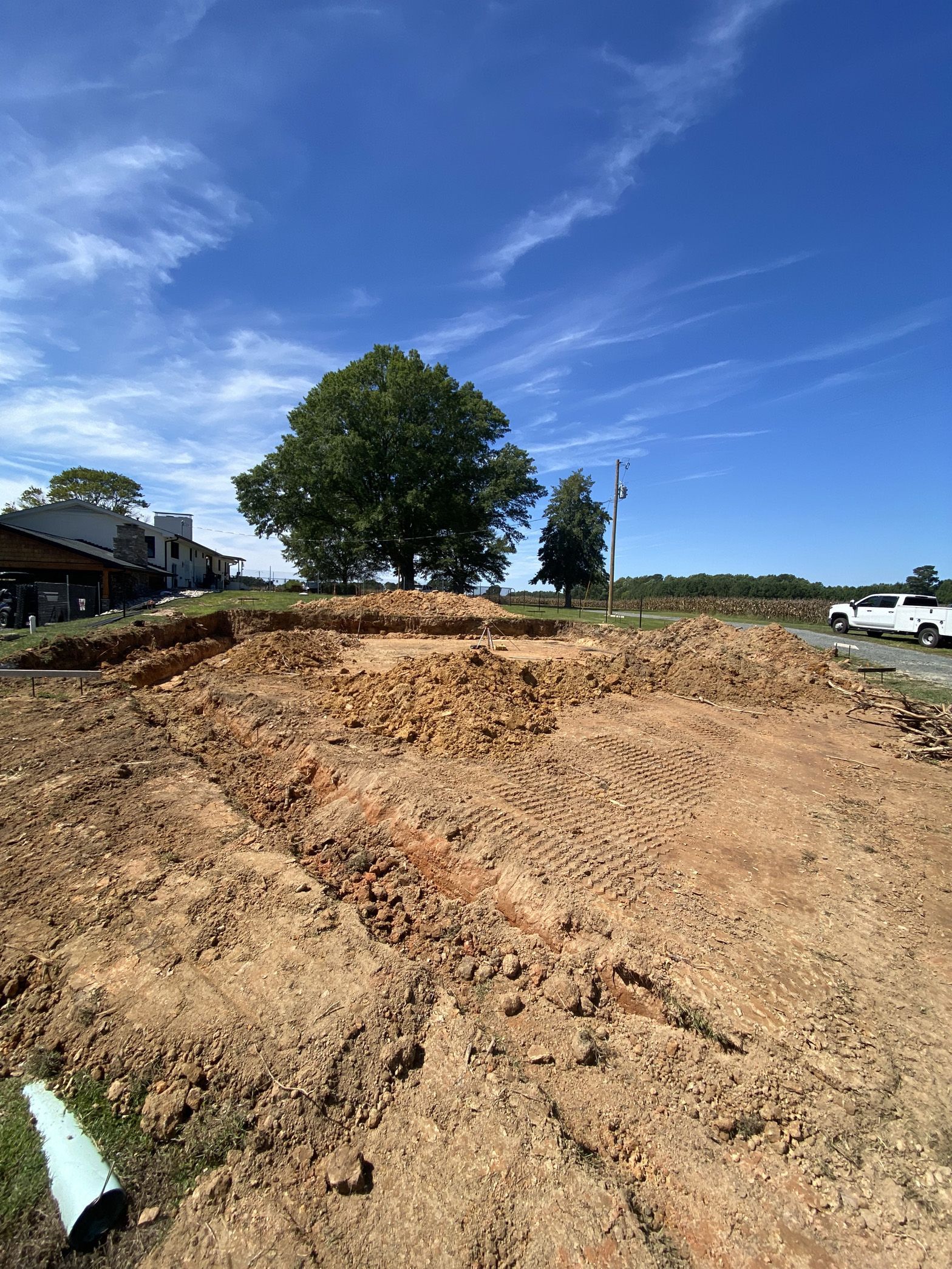 A large pile of dirt is sitting in the middle of a dirt field.