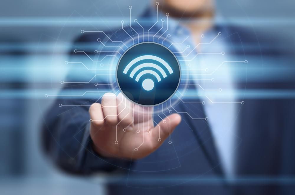 A Man in a Suit is Touching a Wifi Icon on a Screen — River City Communications In Melinga, NSW