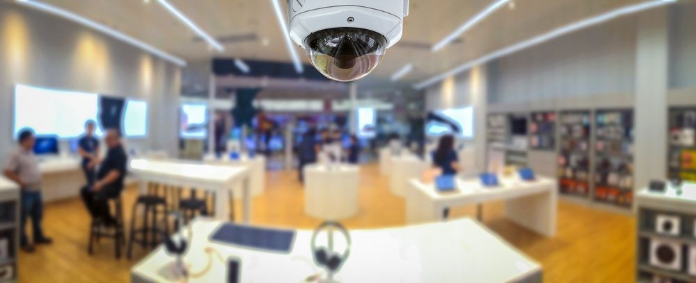 A Security Camera is Hanging From the Ceiling of a Store — River City Communications In Nabiac, NSW