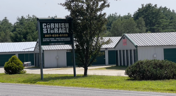 A sign for Cornish Storage is in front of a building