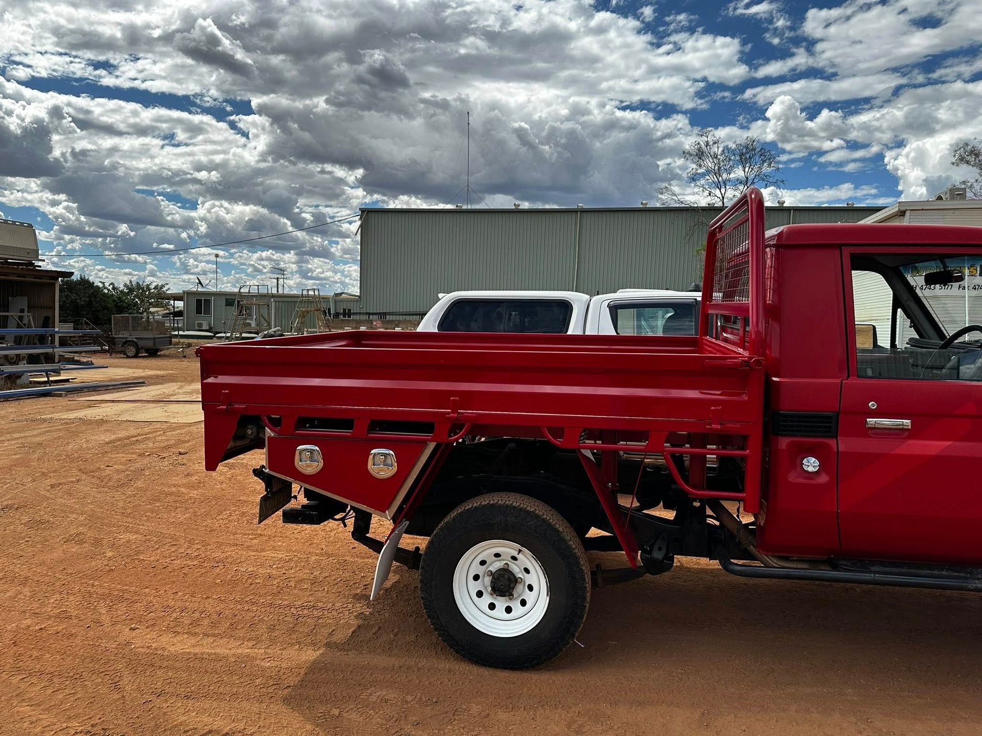A Large Yellow Dumpster is Parked in Front of a Building — Wright's Welding Operations In Ryan, QLD