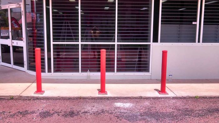 3 red poles — Gates Darwin in Pinelands, NT