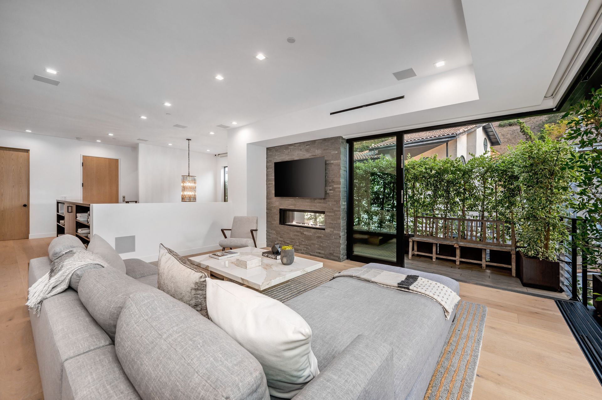 A living room with a couch , table , television and sliding glass doors. Gayle Morris Real Estate | GUIDE Real Estate - Auburn, CA Real Estate
