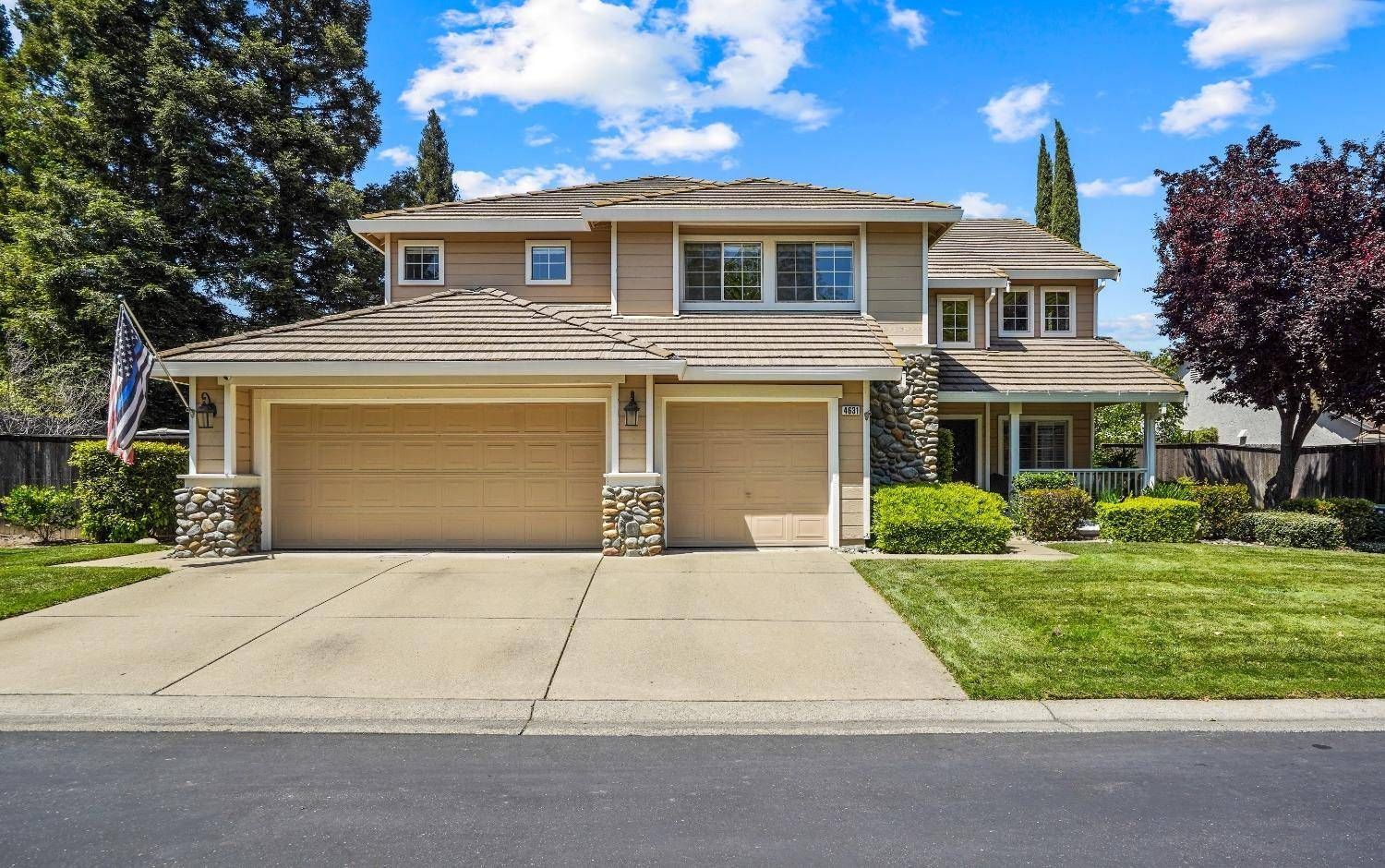 A large house with two garages and a large driveway