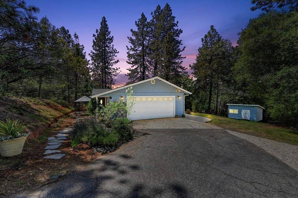 A house with a garage is surrounded by trees at night Gayle Morris  Real Estate | GUIDE Real Estate - Auburn, CA Real Estate