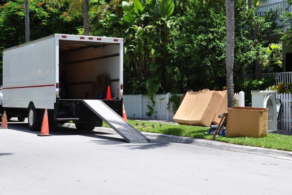 A Moving Truck Parked on a Street With Ramp Down — The Cheapy Shop in Harrington, NSW