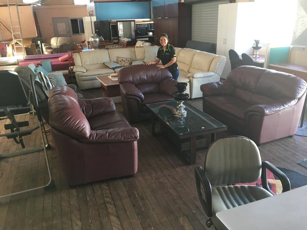 The Cheapy Shop Employee beside Furnitures — Cliffy's Cheaper Removals in Taree, NSW