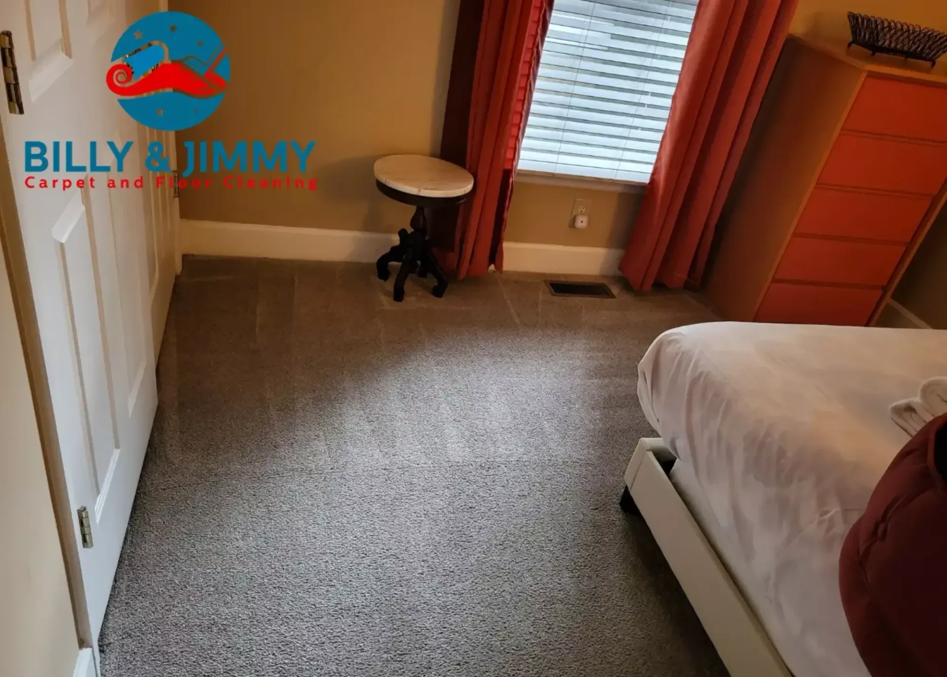 a bedroom with a carpeted floor and a billy & jimmy logo on the wall