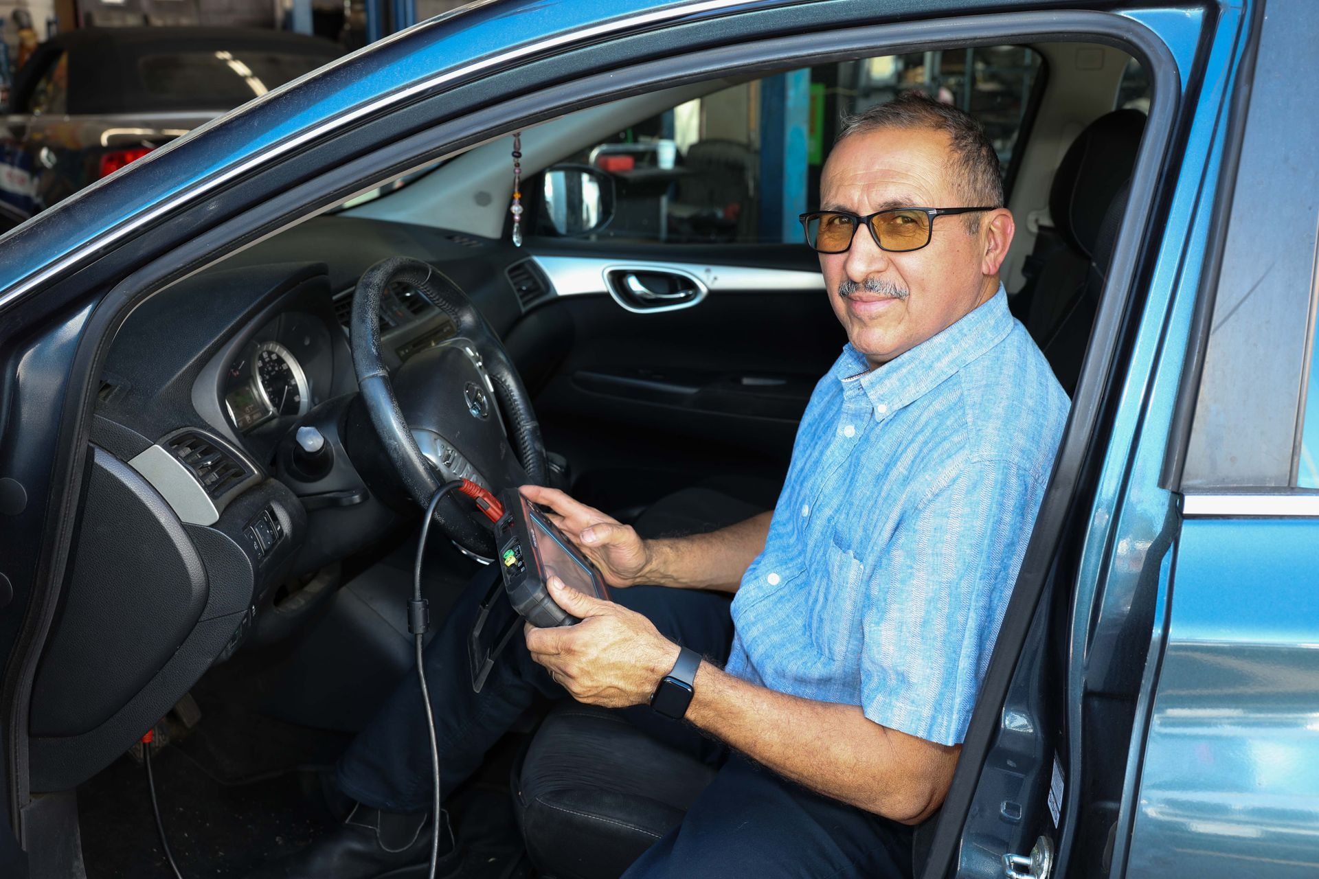 A man in a car | Omega Automotive