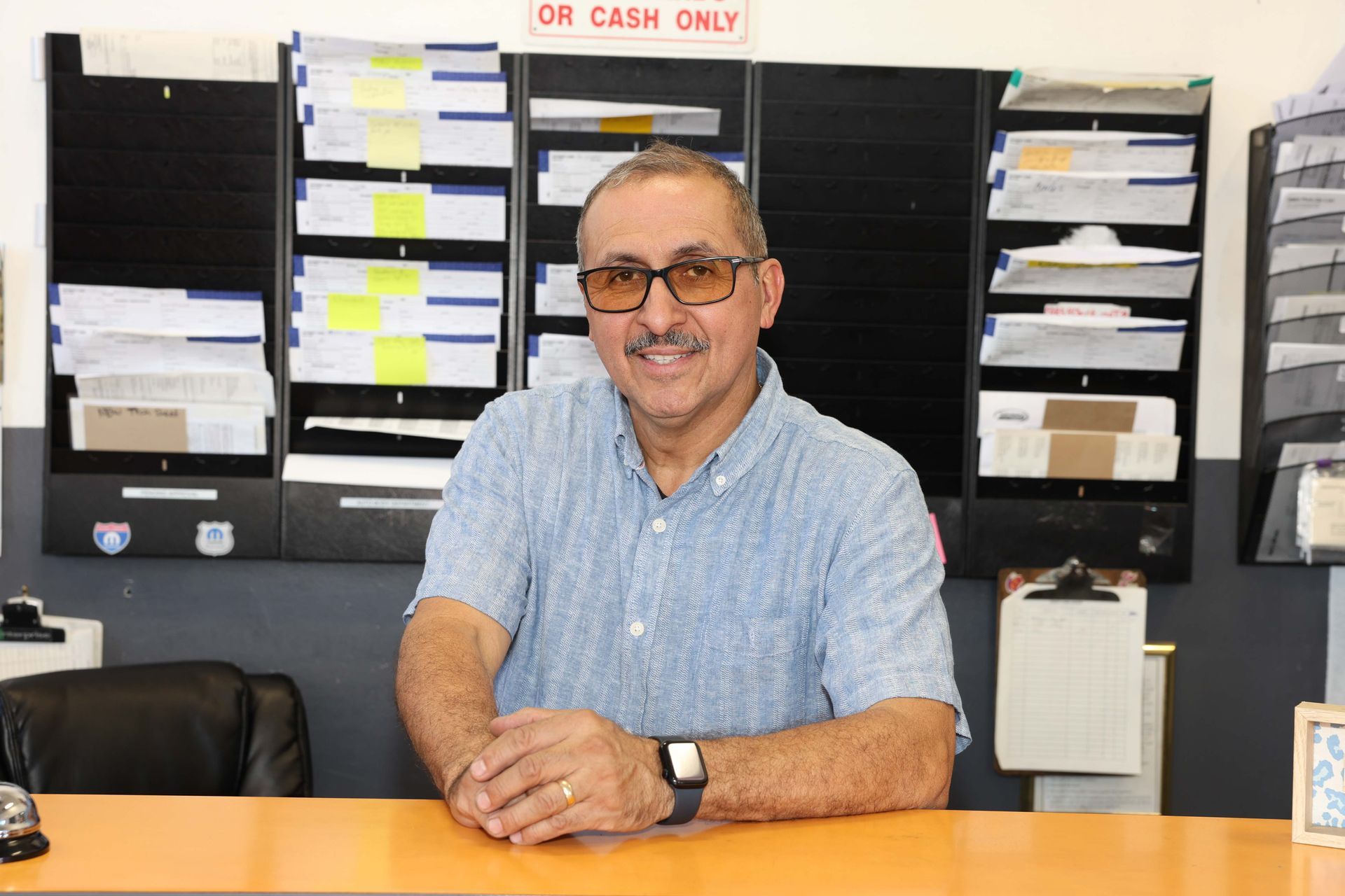 A man in an office | Omega Automotive