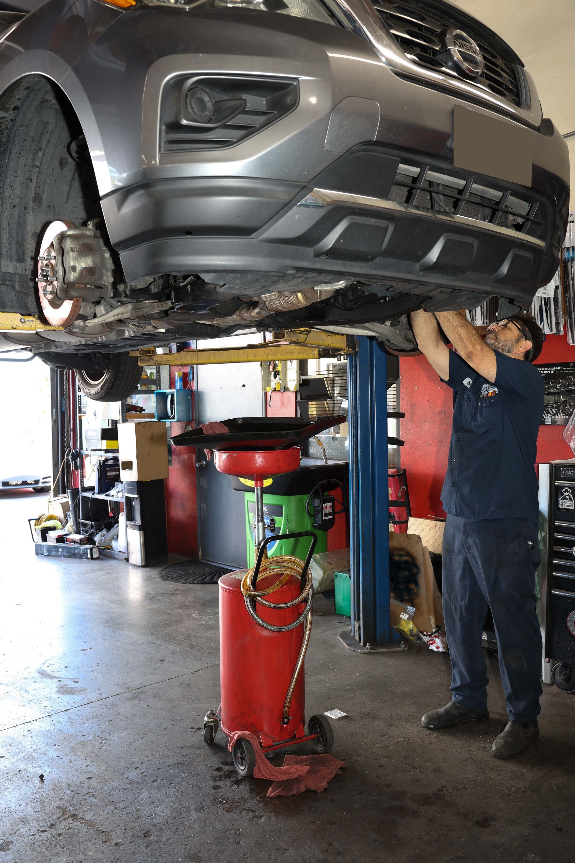 Mechanic working on a car | Omega Automotive