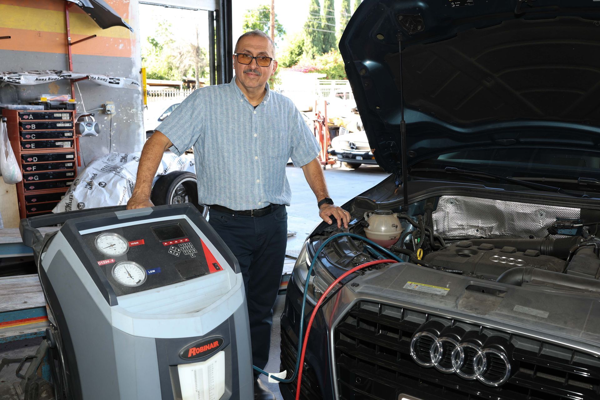 A man next to a car | Omega Automotive