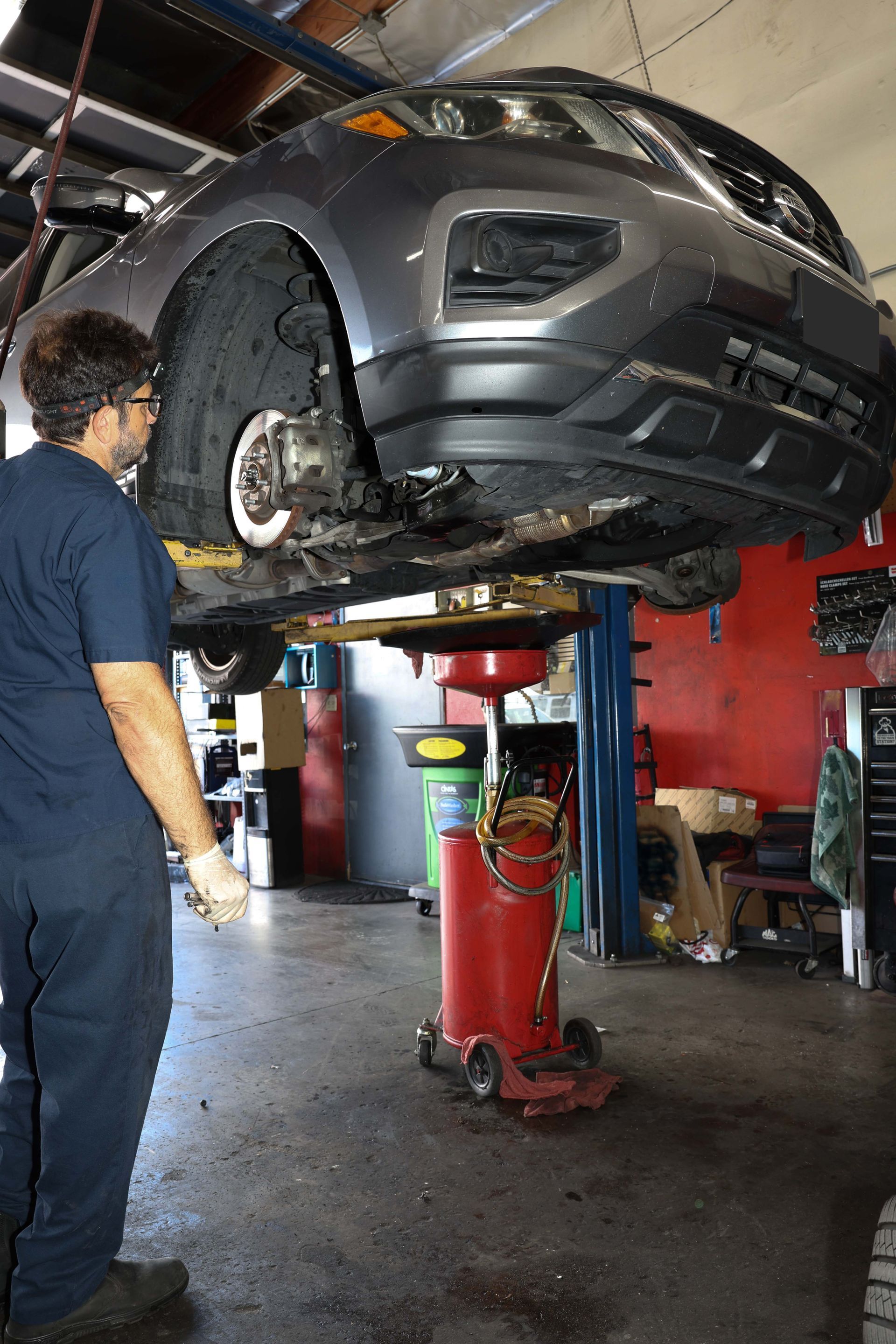 Mechanic next to a car | Omega Automotive