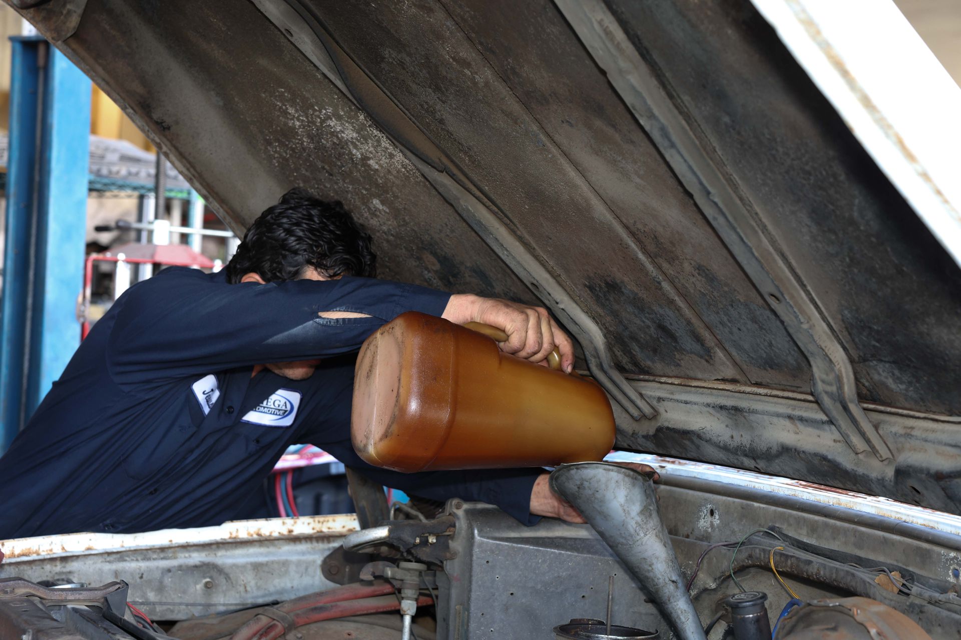Mechanic working on a car | Omega Automotive