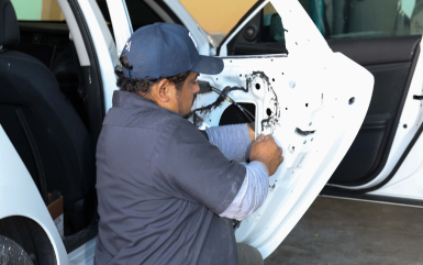 A mechanic working on car | Omega Automotive