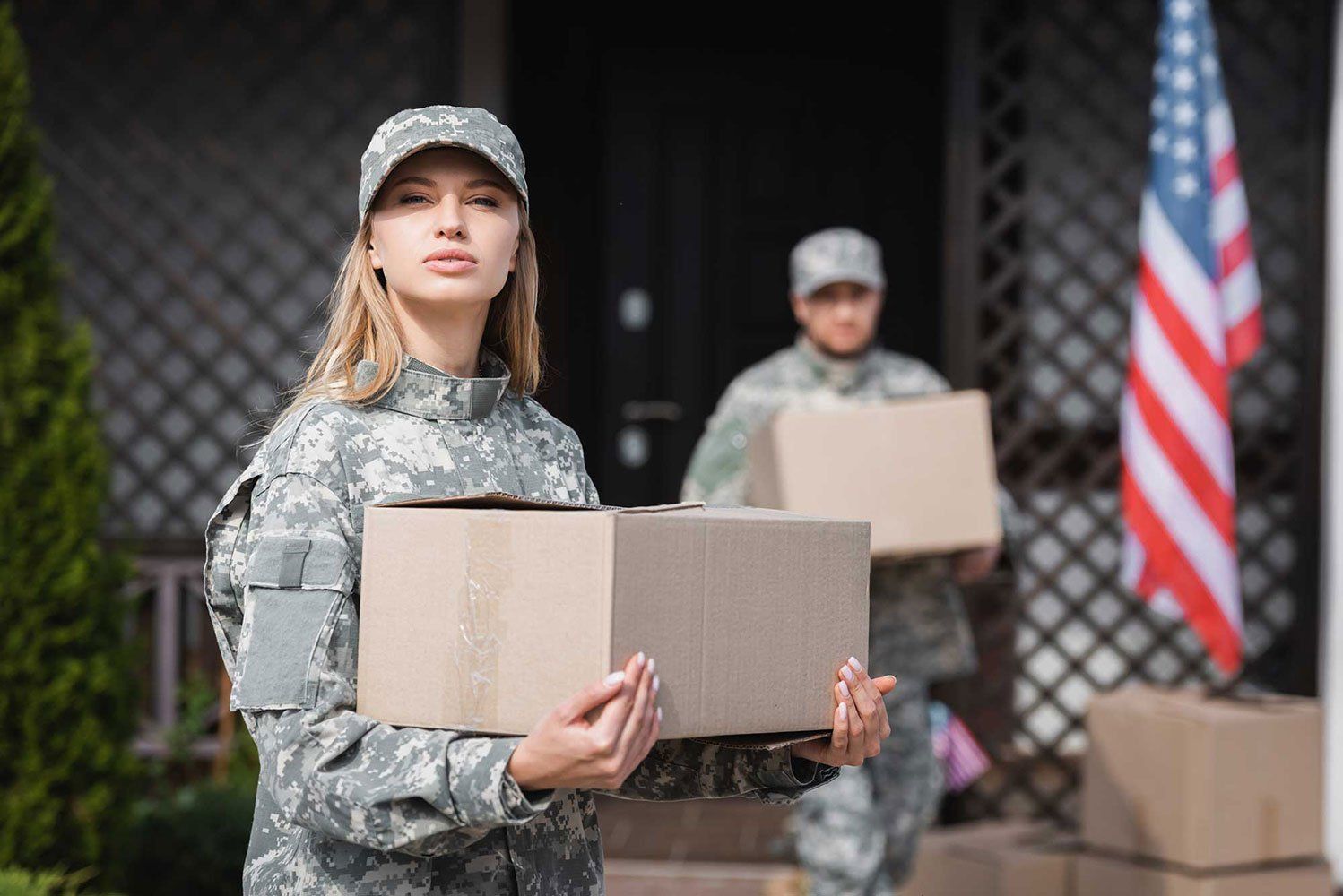Woman in Camouflage Holding Cardboard Box — West Virginia — Watts Brothers Moving