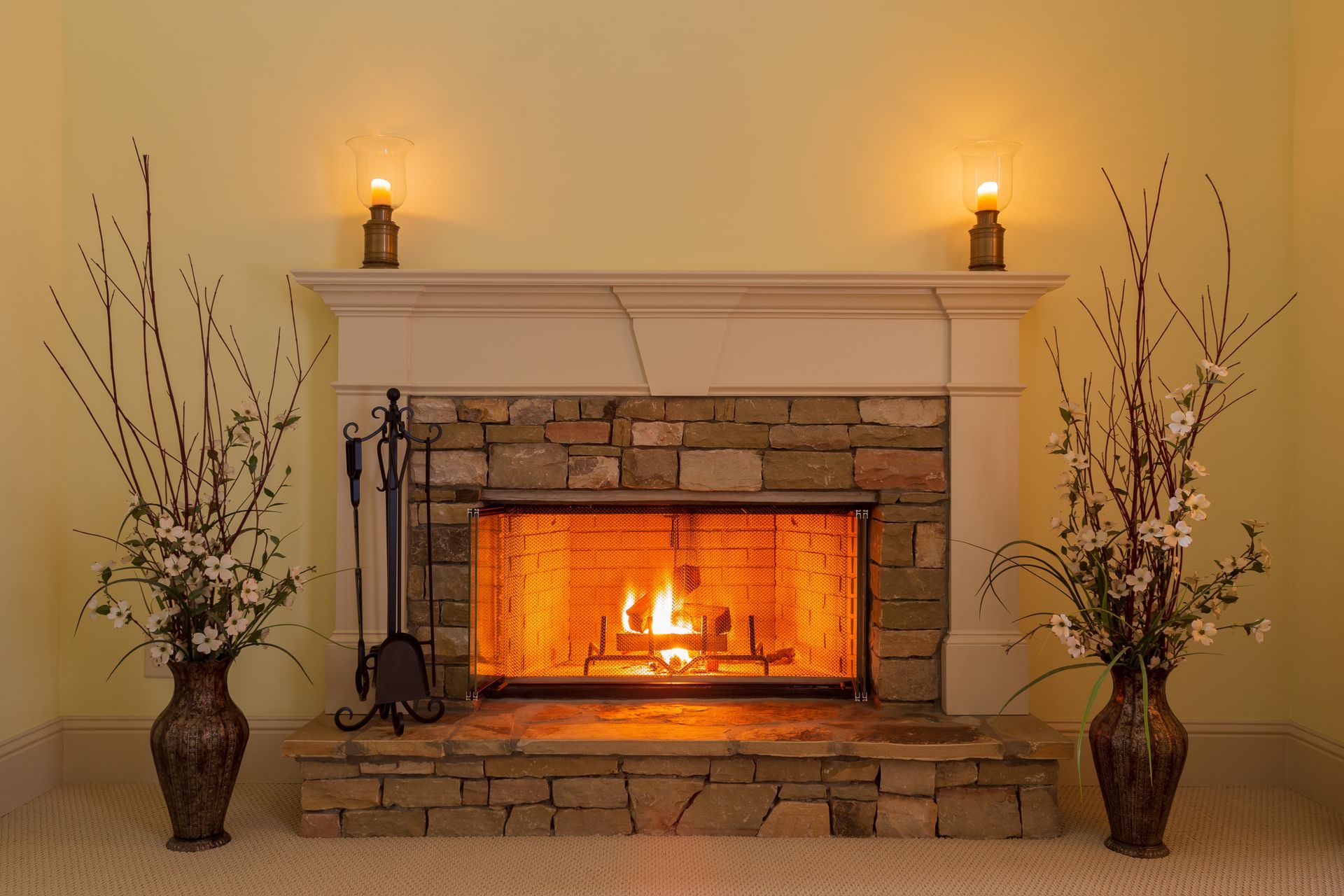 Gas fireplace with seasonal maintenance tools nearby