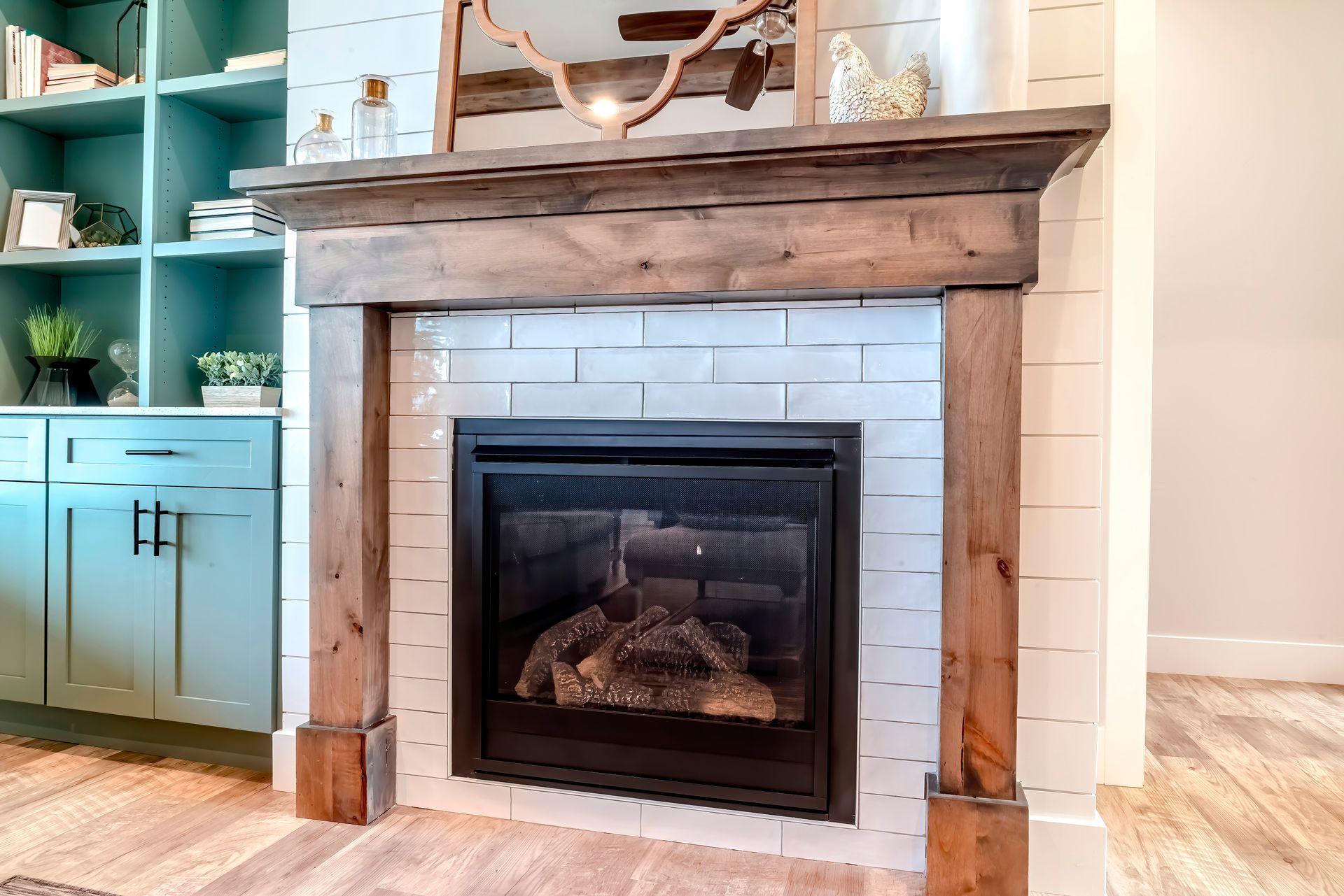 Rustic wood framed fireplace set against white tile in a cozy living room.
