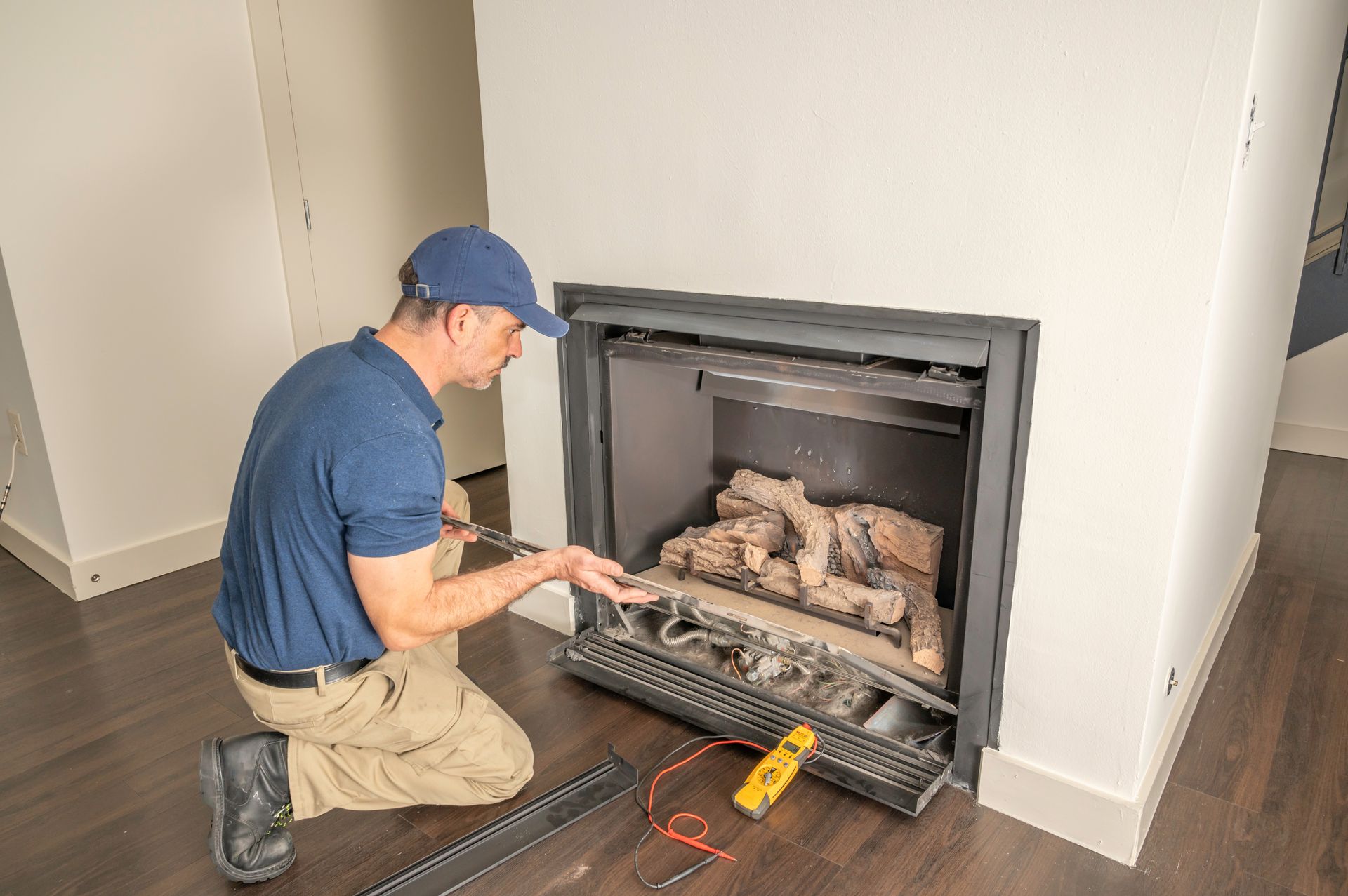 Technician inspecting gas fireplace components