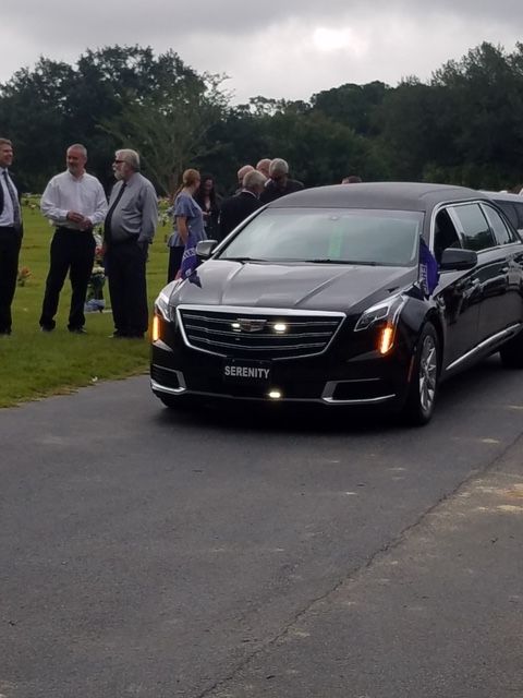 A black Cadillac hearse with 