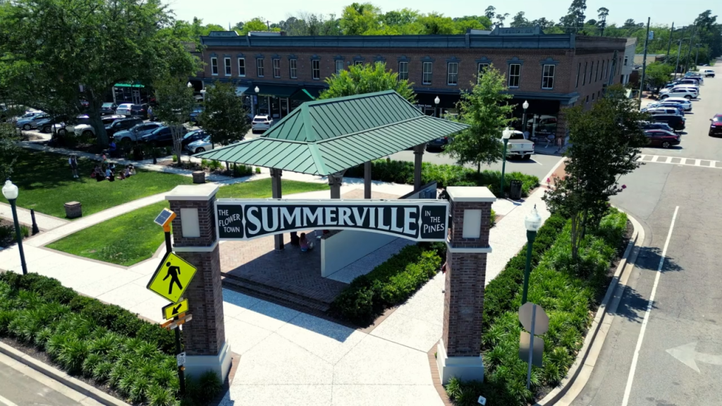 An arched stone entryway with a green roof, marked 