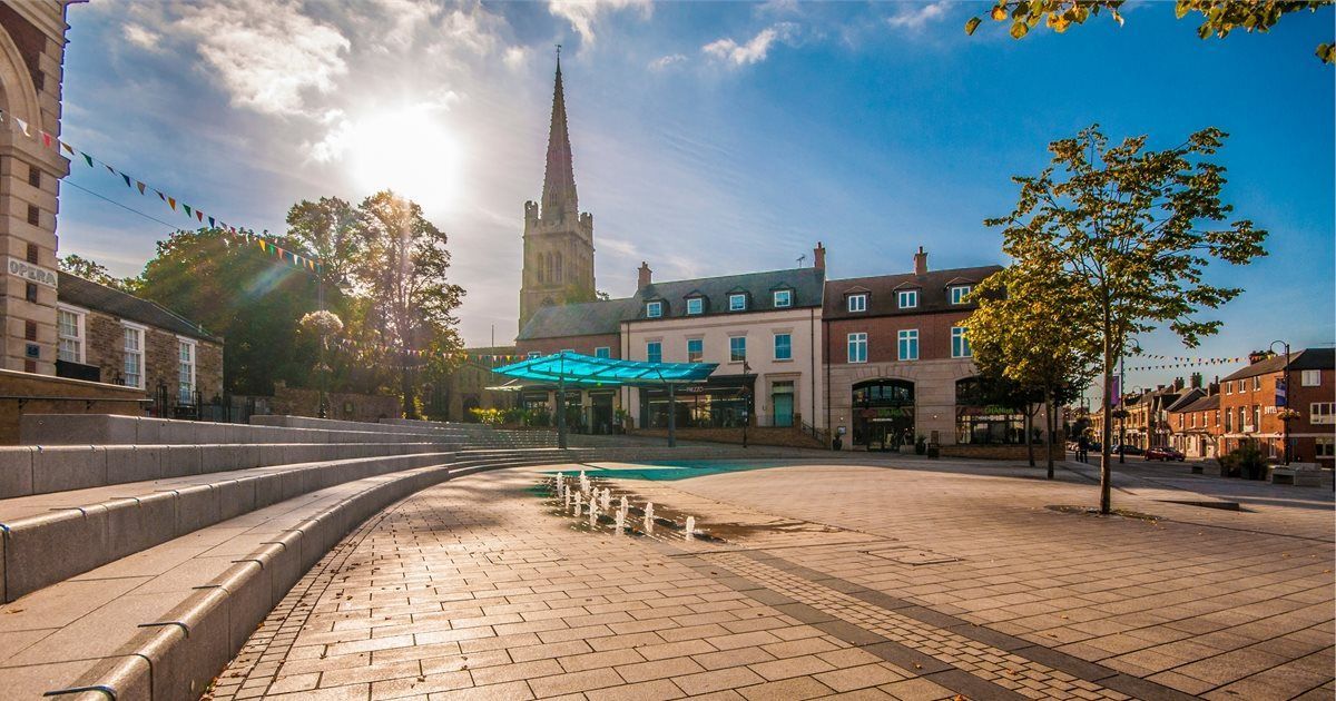 A city square with a church in the background