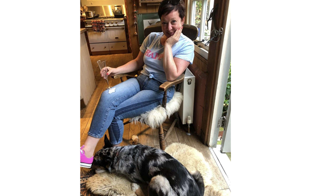 Smiling older man in a suit, tie, and light-colored shirt; head and shoulders shot against a white backdrop.