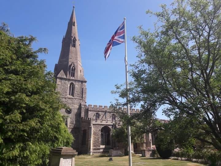 A church with a flag flying in front of it