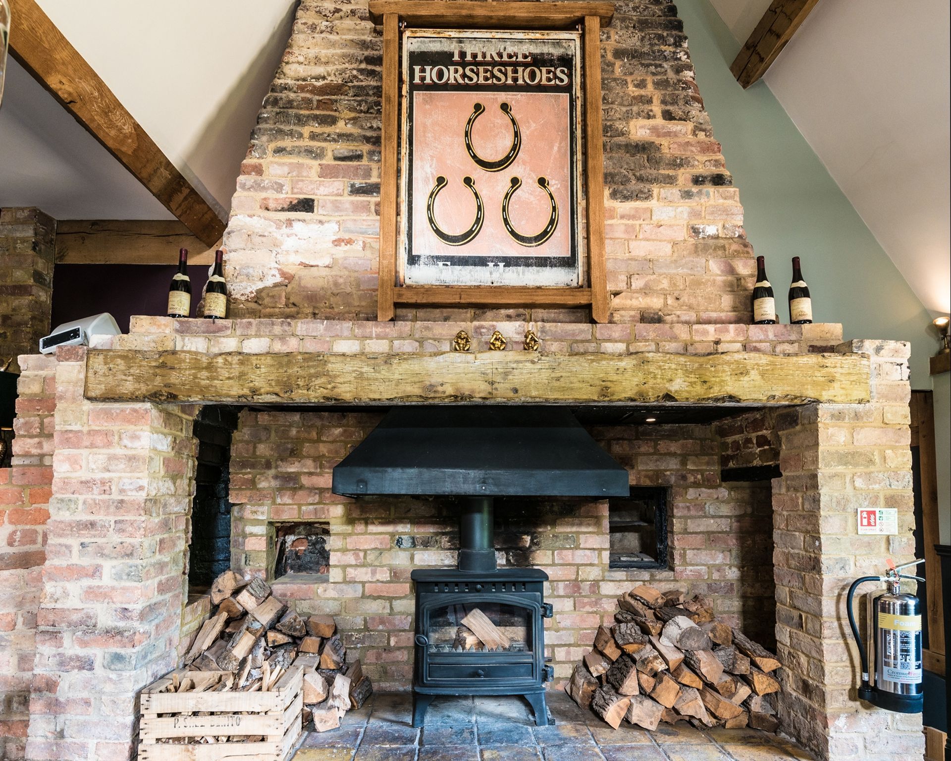 A brick fireplace with a horseshoe sign above it