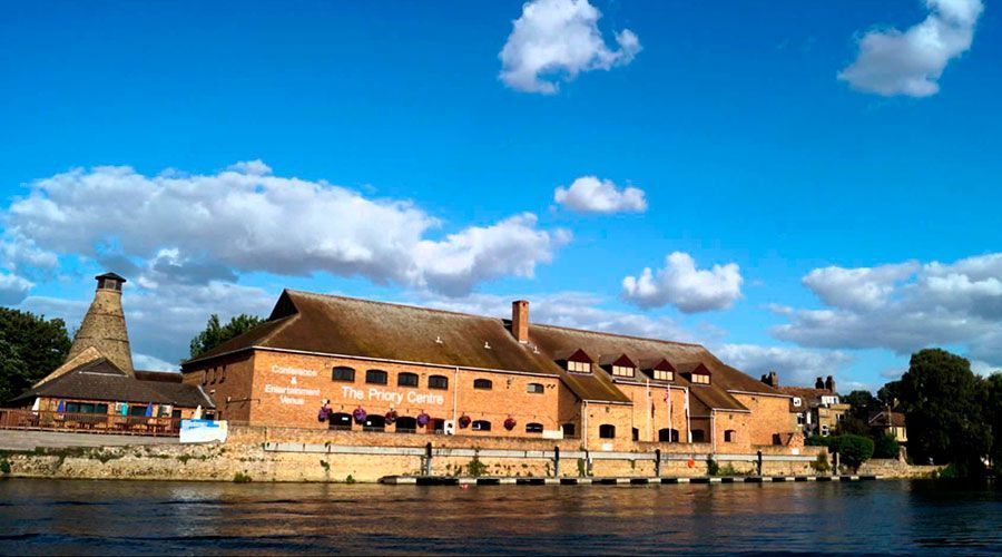 A large brick building with a sign on the side that says ' the penny cross '