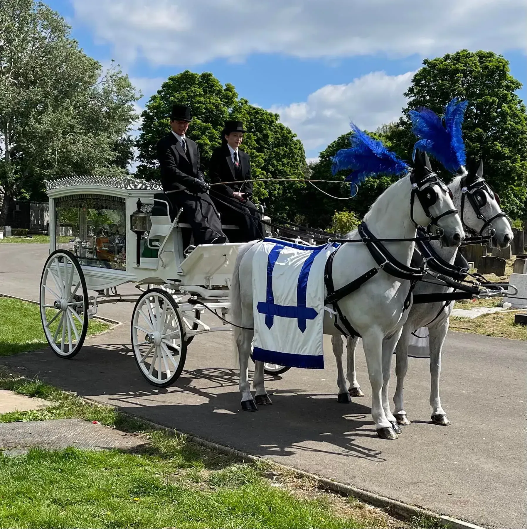 A horse drawn carriage with two men sitting in it