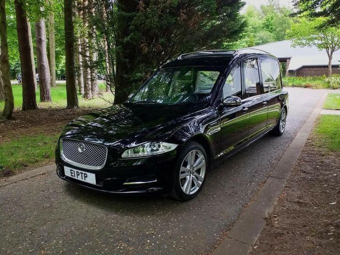 A horse drawn carriage with two men sitting in it