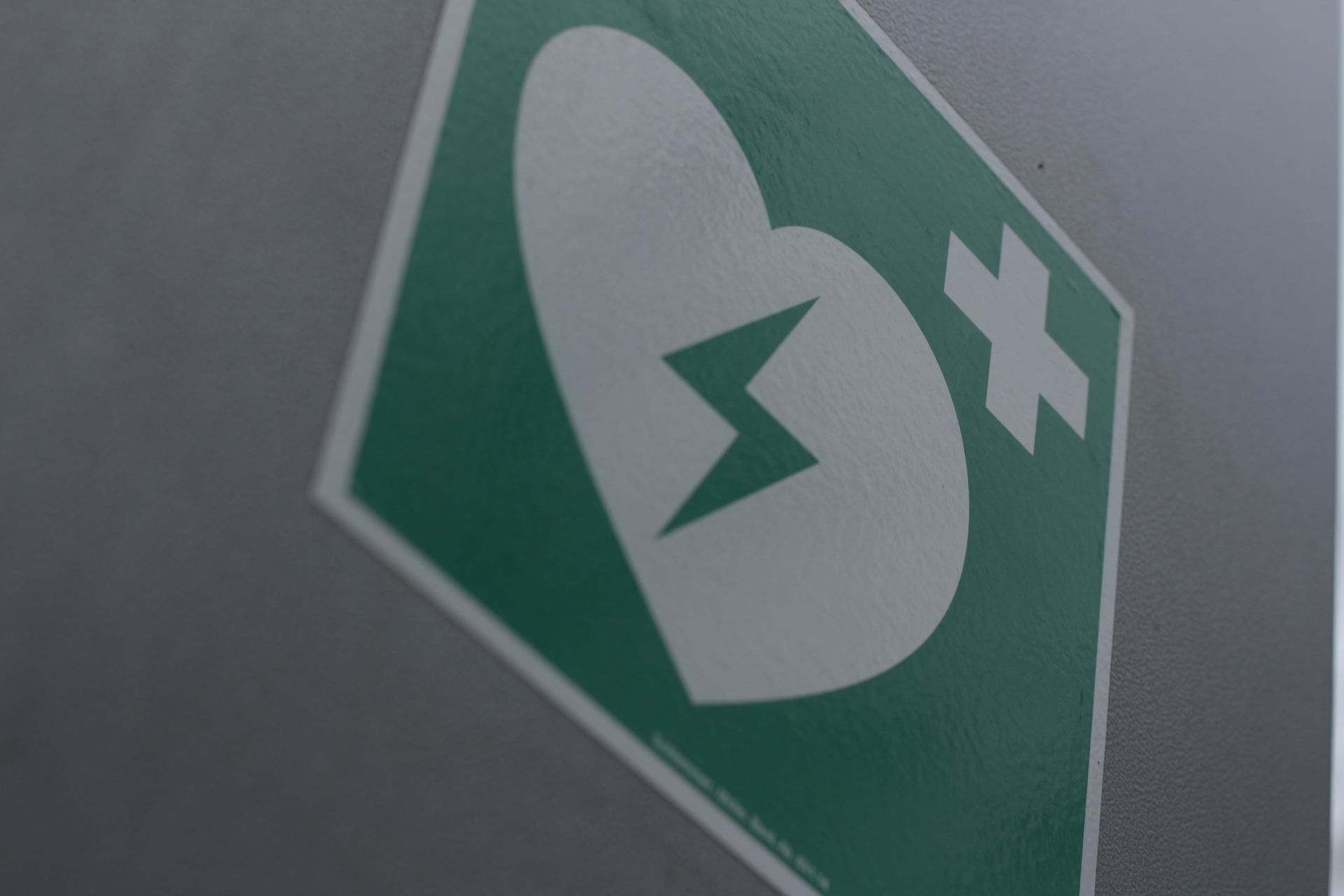 A green sign with a heart and a cross on it