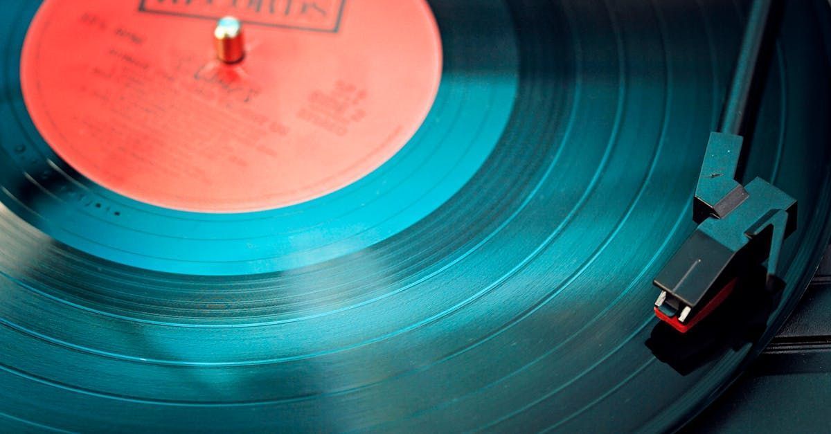 A record player is playing a record with a red label that says ' elvis ' on it