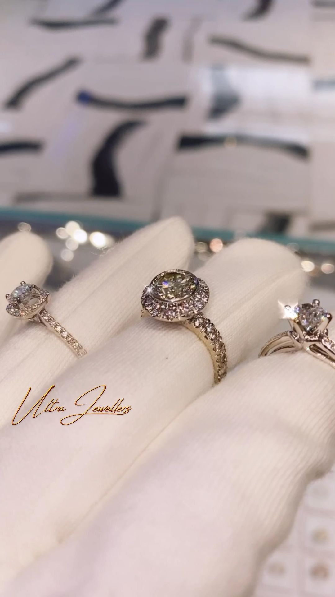 Three rings are stacked on top of each other on a white cloth.