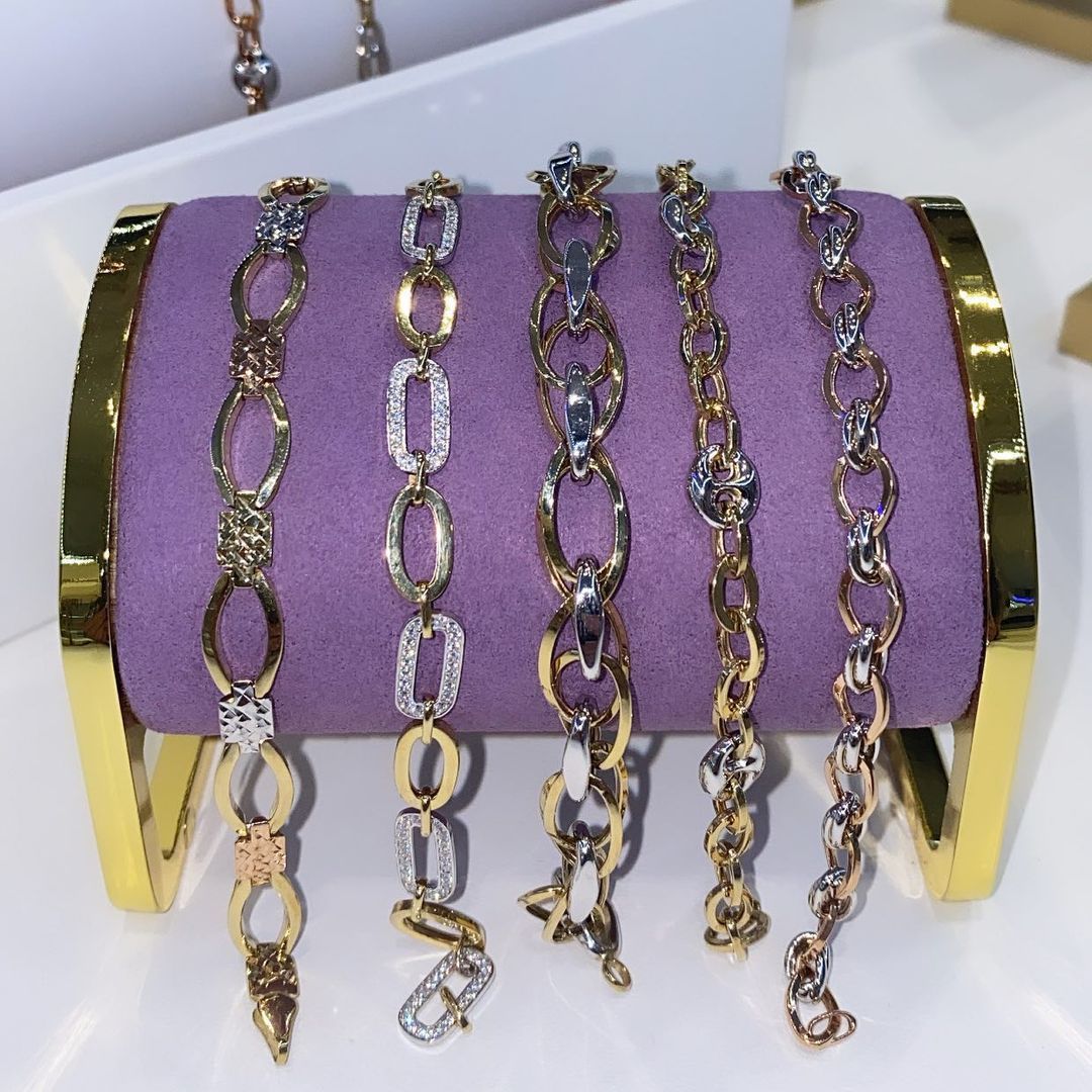 Several bracelets are displayed on a purple cloth