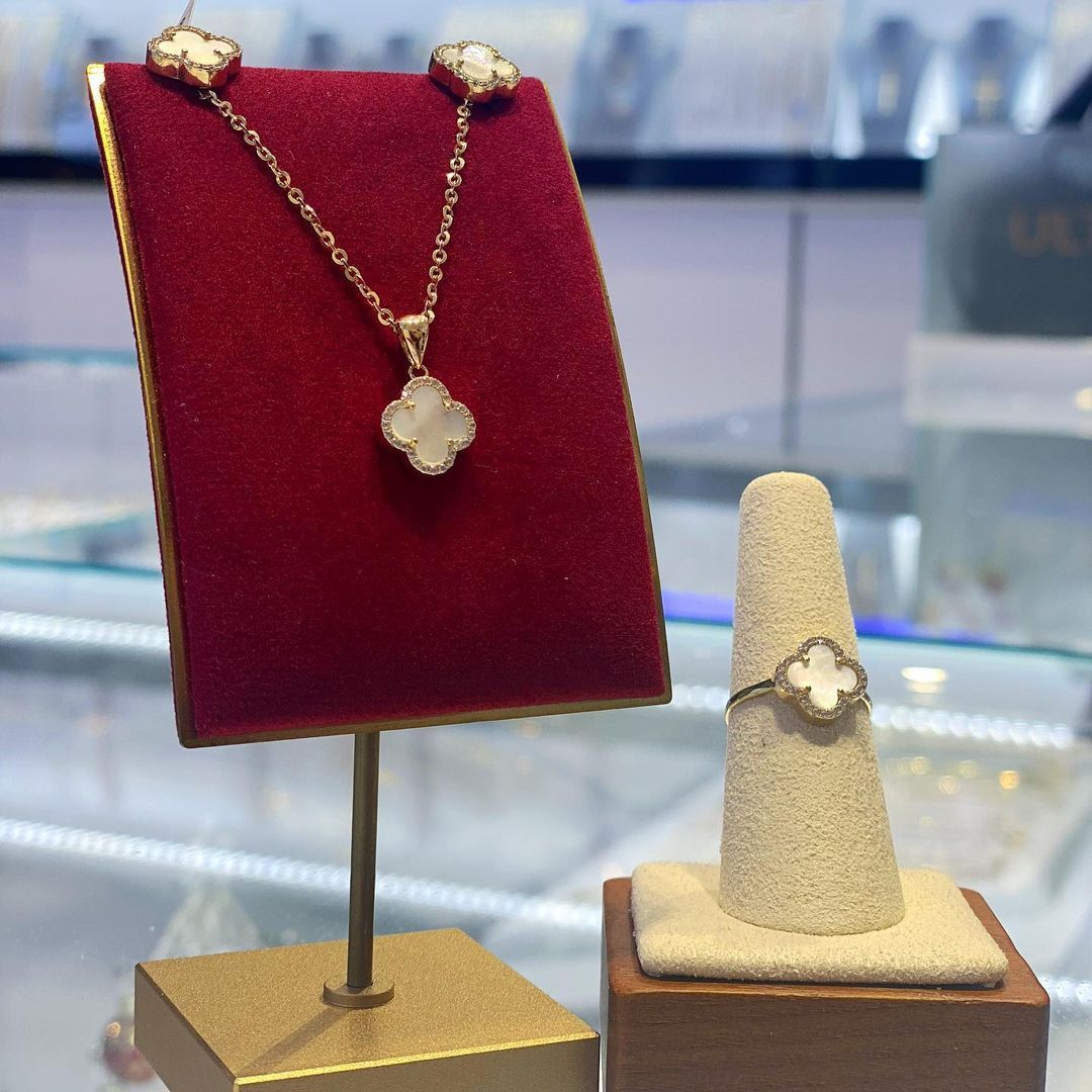 A necklace and a ring are on display in a store