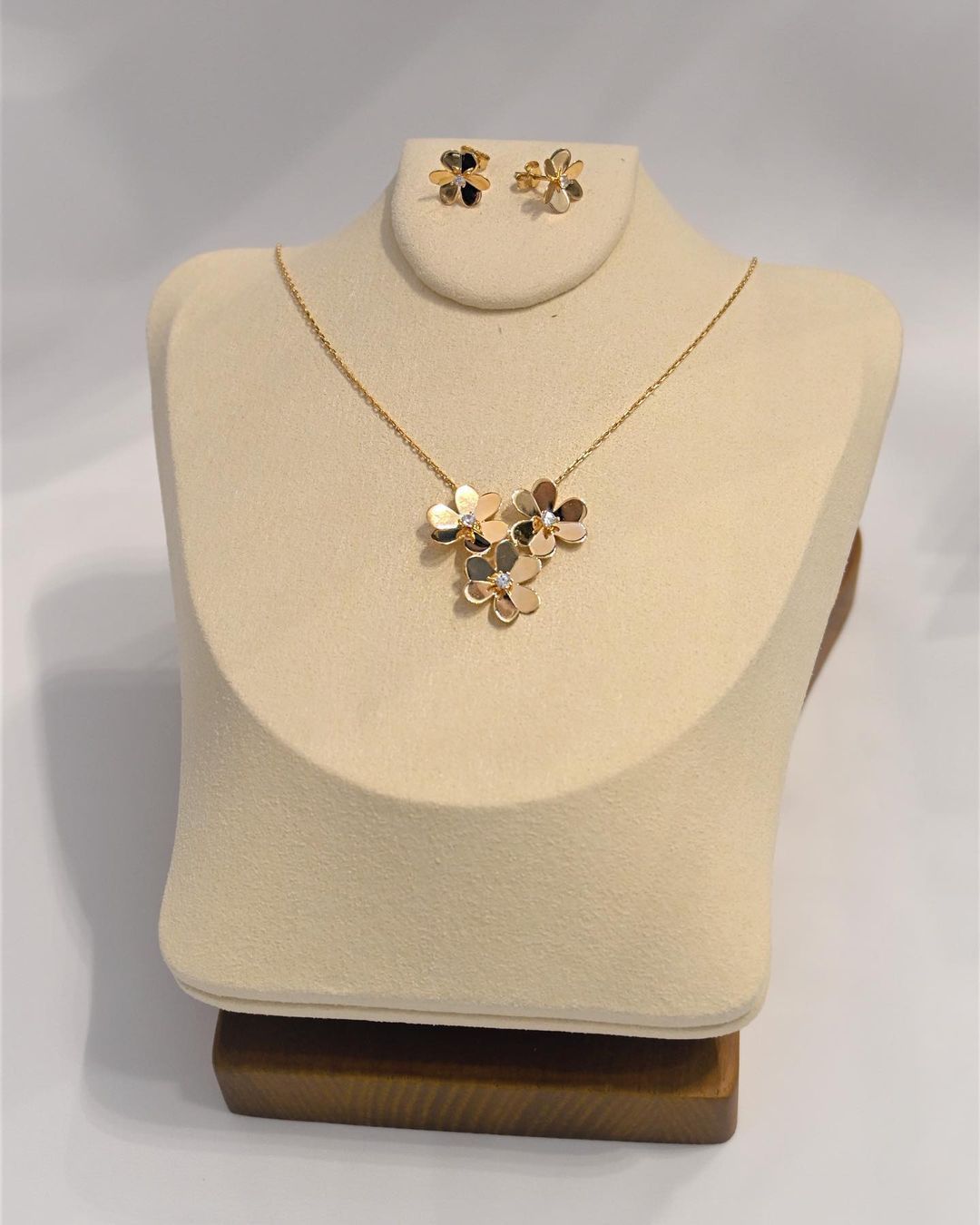 A necklace and earring set on a mannequin