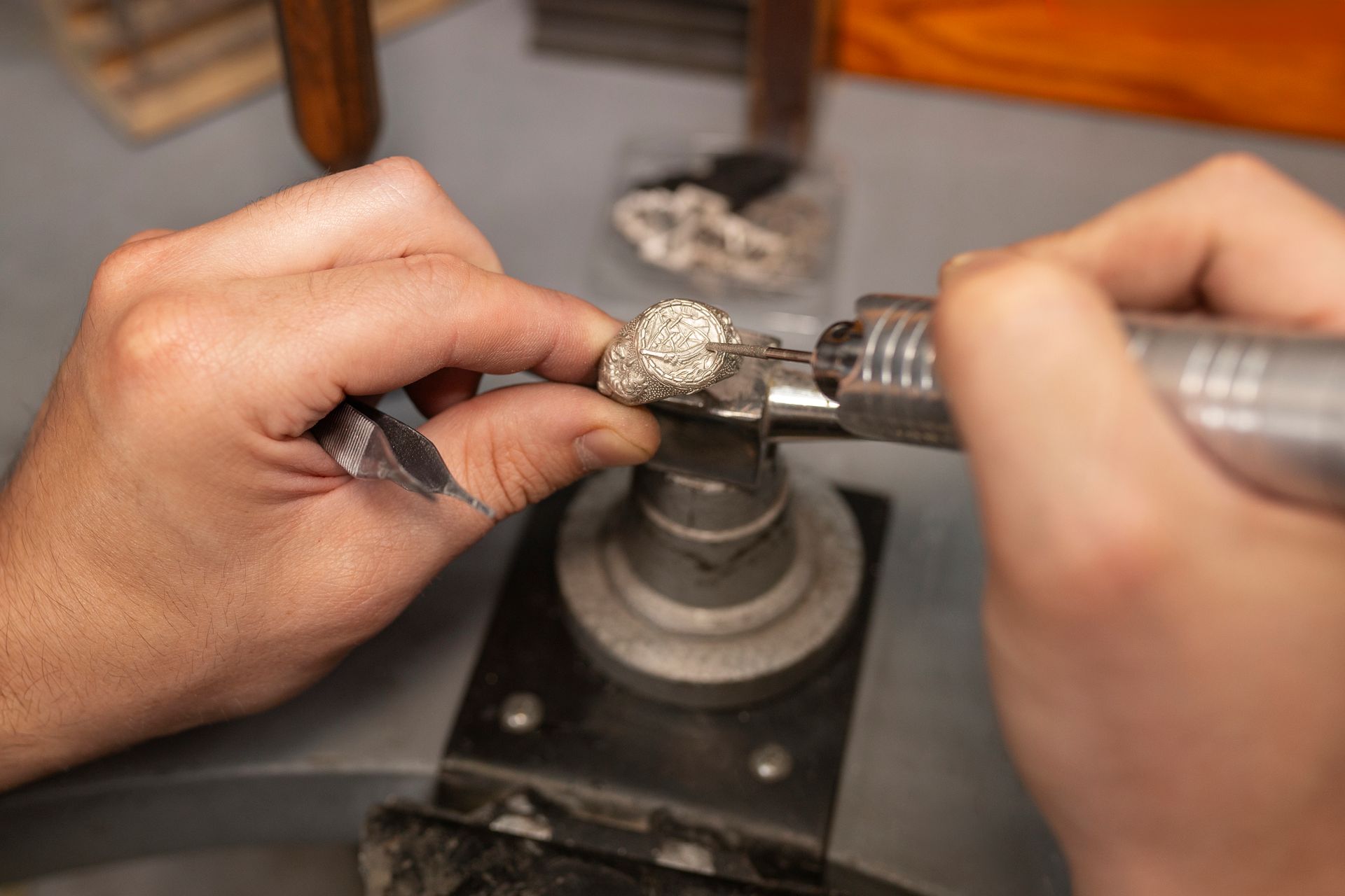 A person is working on a ring with a machine.