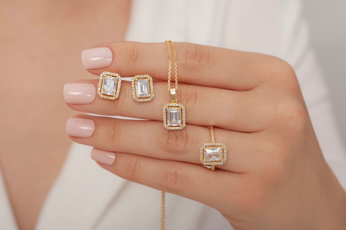 Two gold rings with diamonds on a beige background.