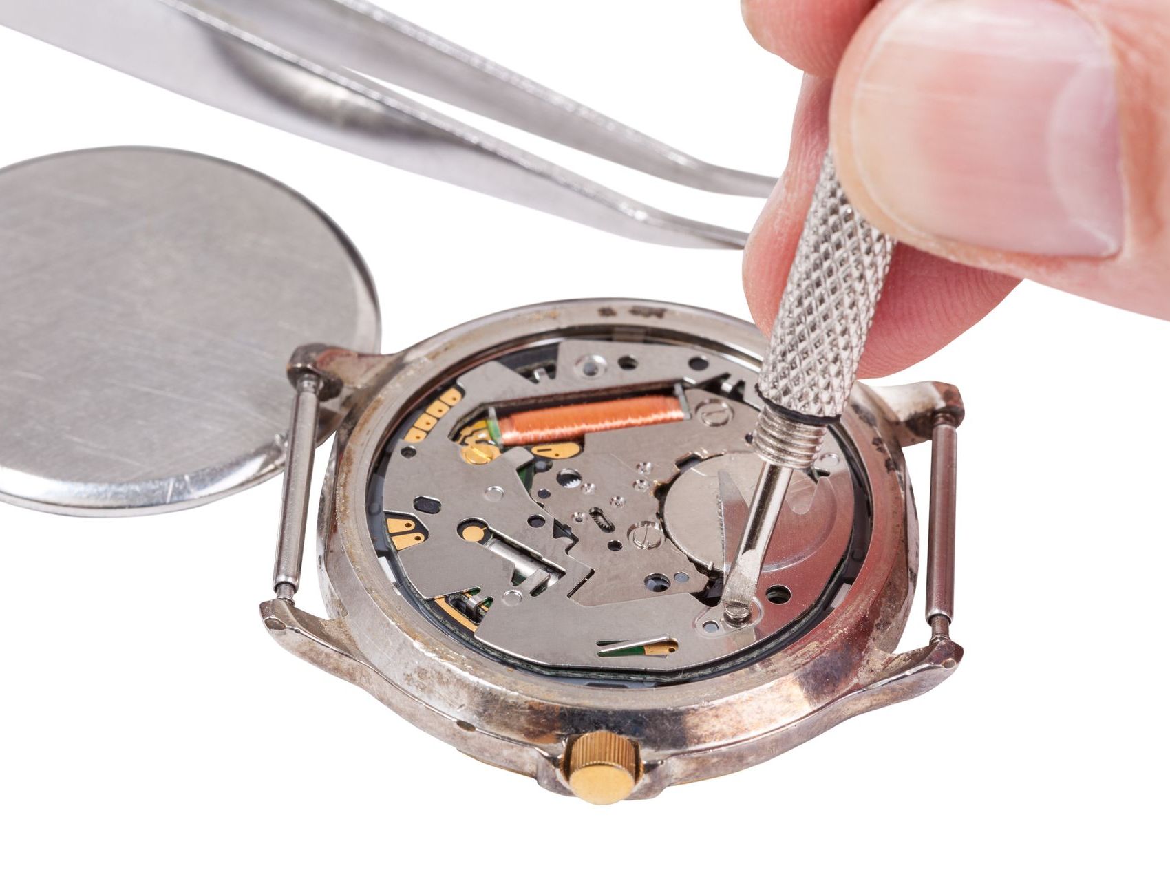 A person is fixing a watch with tweezers