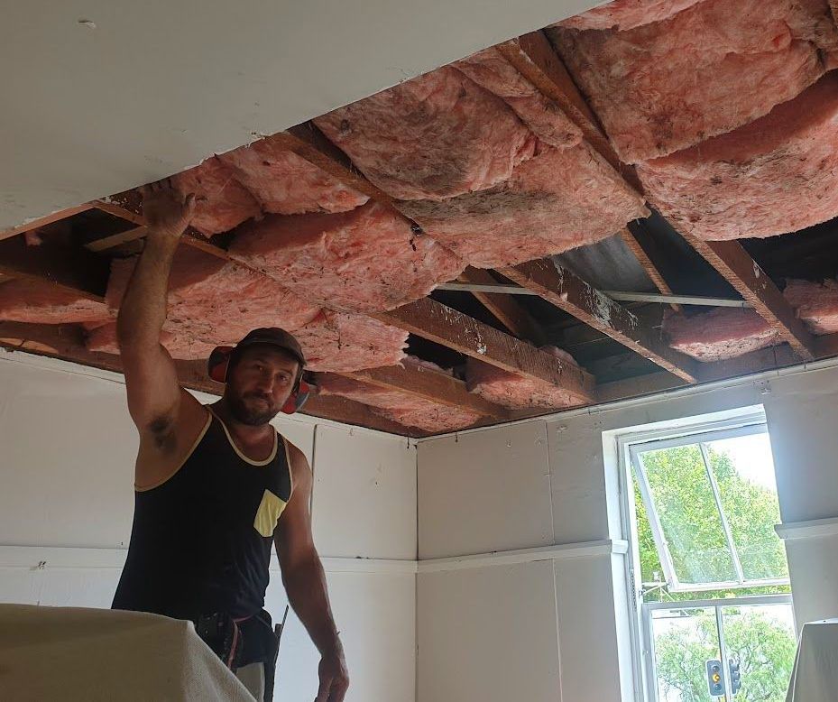 good-looking man working on ceiling