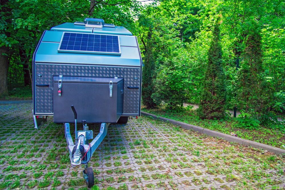 A Trailer With a Solar Panel on Top of It is Parked in a Parking Lot β Auto Electrical Solutions In Pialba, QLD