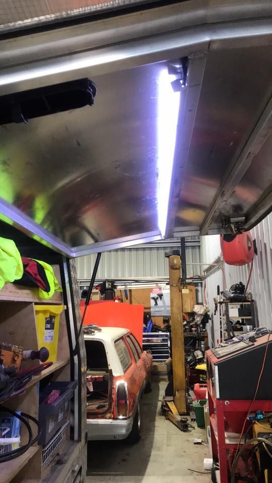 A Car is Parked in a Garage With a Light on the Ceiling — Auto Electrical Solutions In Pialba, QLD