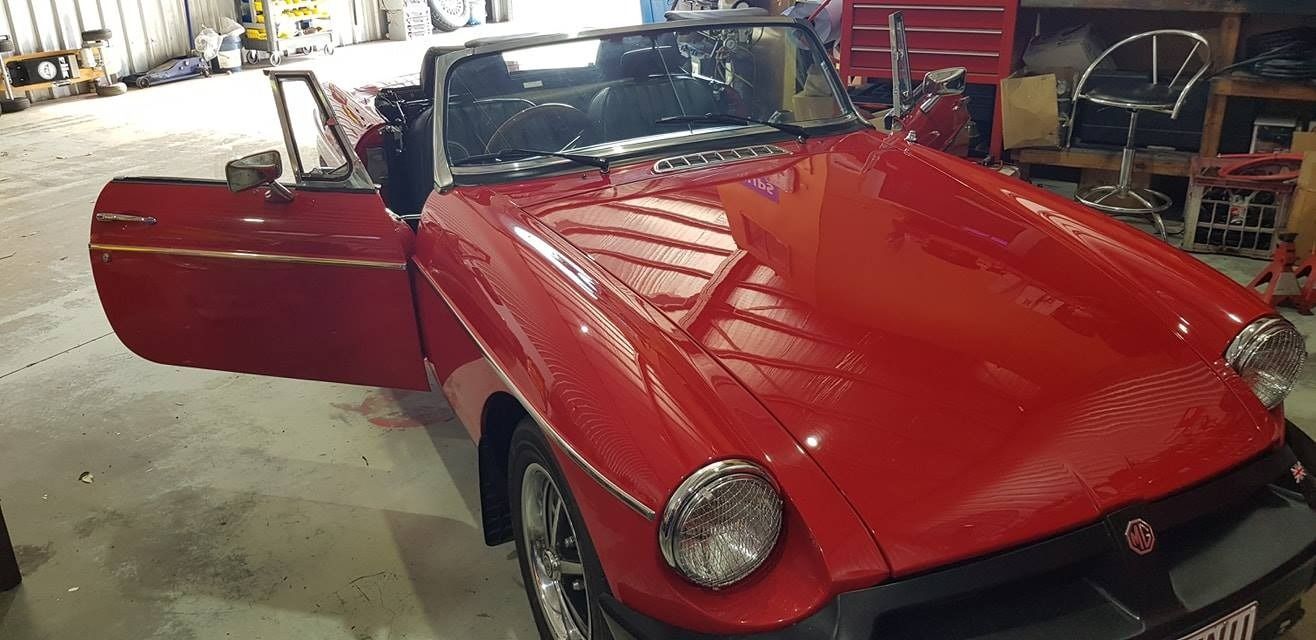 A Red Sports Car Is Parked In A Garage With Its Doors Open β Auto Electrical Solutions In Pialba, QLD